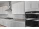 Close-up of a modern kitchen showcasing stainless steel appliances, a range hood, and a granite countertop at 662 W Rock Needle Trl, Apache Junction, AZ 85120