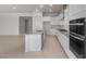 Bright kitchen featuring an island with stainless steel dishwasher and sink, and built in stainless oven and cooktop at 662 W Rock Needle Trl, Apache Junction, AZ 85120
