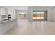 Bright kitchen featuring an island with a sink and bar seating, adjacent to a spacious living area with sliding glass doors at 662 W Rock Needle Trl, Apache Junction, AZ 85120