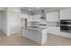 Modern kitchen with white cabinets, granite countertops, stainless steel appliances, and a large center island at 662 W Rock Needle Trl, Apache Junction, AZ 85120