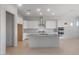 Open kitchen with stainless steel appliances, white cabinets, granite counters, and a center island with sink at 662 W Rock Needle Trl, Apache Junction, AZ 85120