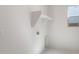 Bright laundry room featuring overhead storage and utility hookups at 662 W Rock Needle Trl, Apache Junction, AZ 85120