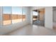 Bright and airy living room with tile floors, large windows, and a sliding glass door leading to the backyard at 662 W Rock Needle Trl, Apache Junction, AZ 85120