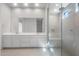 Bright bathroom featuring dual sinks, a large mirror, and a glass-enclosed shower with a rainfall showerhead at 662 W Rock Needle Trl, Apache Junction, AZ 85120
