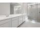 Elegant bathroom featuring dual sinks, sleek cabinetry, and a glass-enclosed shower at 662 W Rock Needle Trl, Apache Junction, AZ 85120