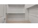 Organized walk-in closet with multiple shelves and hanging rods for ample storage at 662 W Rock Needle Trl, Apache Junction, AZ 85120