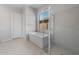 Relaxing bathroom featuring a soaker tub, glass-enclosed shower, and bright natural light at 674 W Rock Needle Trl, Apache Junction, AZ 85120