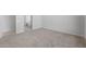 Spacious bedroom featuring neutral carpet and a doorway to an ensuite bathroom at 674 W Rock Needle Trl, Apache Junction, AZ 85120