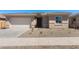 Charming single-story home featuring a two-car garage and freshly xeriscaped front yard at 674 W Rock Needle Trl, Apache Junction, AZ 85120