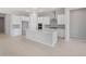Spacious kitchen with white cabinets, stainless steel appliances, and a large center island with seating at 674 W Rock Needle Trl, Apache Junction, AZ 85120