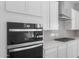 Modern kitchen details showcasing built-in double ovens, quartz countertops, and white shaker cabinets at 674 W Rock Needle Trl, Apache Junction, AZ 85120