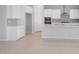 Bright kitchen with white cabinets, stainless steel appliances, tile backsplash, and island with breakfast bar at 674 W Rock Needle Trl, Apache Junction, AZ 85120