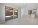 Spacious living area featuring sliding glass doors to a patio, neutral walls, and tile flooring at 674 W Rock Needle Trl, Apache Junction, AZ 85120