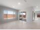 Bright, open living room with multiple windows and sliding glass doors offering abundant natural light at 674 W Rock Needle Trl, Apache Junction, AZ 85120