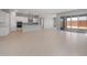 Spacious living room and kitchen area with tile flooring and access to outdoor patio via sliding glass doors at 674 W Rock Needle Trl, Apache Junction, AZ 85120
