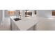 Open-concept living area with kitchen island, tile flooring, and sliding doors leading to outdoor space at 674 W Rock Needle Trl, Apache Junction, AZ 85120