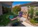 A lush backyard with potted plants and outdoor grill station at 6855 E Amber Sun Dr, Scottsdale, AZ 85266