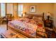 A bedroom featuring a colorful quilt bed and rustic wooden furniture at 6855 E Amber Sun Dr, Scottsdale, AZ 85266