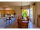 Charming dining area with a wooden table, stylish lighting, and a view of the lush outdoor scenery at 6855 E Amber Sun Dr, Scottsdale, AZ 85266