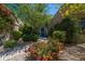 Inviting front entrance with colorful desert landscaping and a secure screen door at 6855 E Amber Sun Dr, Scottsdale, AZ 85266