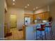Bright kitchen featuring counter seating, modern appliances, and tile flooring, ideal for casual dining at 6855 E Amber Sun Dr, Scottsdale, AZ 85266