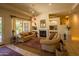 Cozy living room with a fireplace, built-in shelving, and comfortable couches, perfect for relaxation at 6855 E Amber Sun Dr, Scottsdale, AZ 85266