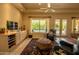 Inviting living room with a large window overlooking the pool, built-in cabinets, and comfortable seating at 6855 E Amber Sun Dr, Scottsdale, AZ 85266