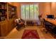 Cozy office space featuring built-in bookshelves and a comfortable sitting area at 6855 E Amber Sun Dr, Scottsdale, AZ 85266
