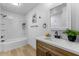 Bright bathroom with modern vanity, elegant mirror, and tub/shower combo at 7836 E Juanita Ave, Mesa, AZ 85208