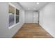 Light-filled bedroom featuring clean lines, window, and hardwood floors at 7836 E Juanita Ave, Mesa, AZ 85208
