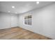 Bright bedroom with light hardwood floors and a large window at 7836 E Juanita Ave, Mesa, AZ 85208