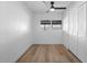 Light and airy bedroom with white walls, fan, and new floors at 7836 E Juanita Ave, Mesa, AZ 85208