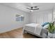 Cozy bedroom featuring a ceiling fan, a window, and new floors at 7836 E Juanita Ave, Mesa, AZ 85208