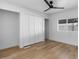 Bright bedroom featuring a ceiling fan, closet, and new floors at 7836 E Juanita Ave, Mesa, AZ 85208