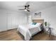 Bedroom featuring a bed, ceiling fan, view of the bath, and new floors at 7836 E Juanita Ave, Mesa, AZ 85208