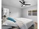 Calm bedroom with a ceiling fan, light hardwood floor, and bright window at 7836 E Juanita Ave, Mesa, AZ 85208