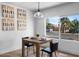Bright dining area with modern table set and a view of the neighborhood landscape at 7836 E Juanita Ave, Mesa, AZ 85208