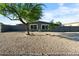 Charming home with a well-maintained xeriscaped front yard and mature trees at 7836 E Juanita Ave, Mesa, AZ 85208