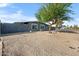 Charming single-story home with a low-maintenance gravel front yard and a mature shade tree at 7836 E Juanita Ave, Mesa, AZ 85208