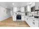 Contemporary kitchen featuring white cabinets, a stainless steel range, and new finishes at 7836 E Juanita Ave, Mesa, AZ 85208