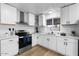 Bright kitchen featuring white cabinets, stainless steel appliances, and modern countertops at 7836 E Juanita Ave, Mesa, AZ 85208