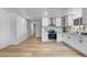 A full view of the bright kitchen featuring stainless steel appliances, white cabinets and light filled window at 7836 E Juanita Ave, Mesa, AZ 85208