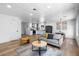 Open concept living area featuring a modern sofa and seamless flow into the updated kitchen at 7836 E Juanita Ave, Mesa, AZ 85208