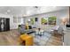 Open-concept living room boasts a sofa, stylish decor, and seamless flow for modern living at 7836 E Juanita Ave, Mesa, AZ 85208