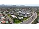 An elevated view showcasing a residential complex near stores, featuring mature trees and accessible roads at 8260 E Arabian Trl # 257, Scottsdale, AZ 85258