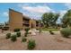 Apartment building with manicured grounds featuring grassy areas, shrubbery, park benches, and community pool access at 8260 E Arabian Trl # 257, Scottsdale, AZ 85258