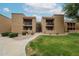 Apartment building featuring private patios, covered terraces, and landscaped grounds with mature trees and shrubbery at 8260 E Arabian Trl # 257, Scottsdale, AZ 85258
