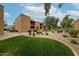 Apartment building with manicured grounds including grassy areas, shrubbery, walkways, and benches for residents at 8260 E Arabian Trl # 257, Scottsdale, AZ 85258