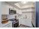 Modern kitchen featuring sleek white cabinets and stainless steel appliances at 8260 E Arabian Trl # 257, Scottsdale, AZ 85258