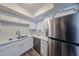 Elegant kitchen with stainless steel appliances and white cabinets providing ample storage at 8260 E Arabian Trl # 257, Scottsdale, AZ 85258